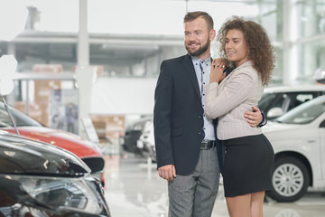 Fototapeta na wymiar Couple choosing automobile in car center.