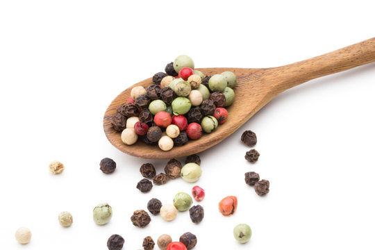 Pepper mix seed on spoon on white background.