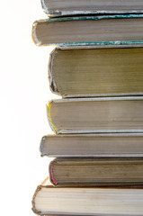 Stack of old books on white background