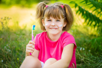 Happy little girl brushing her teeth. Dental hygiene. Healthy concept