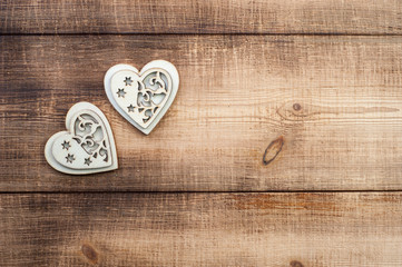 Two wood heart on a vintage wooden background.