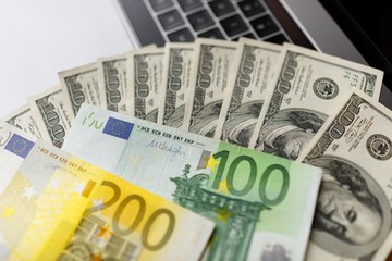 Background with american dollar and euro bills.