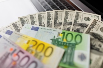 Background with american dollar and euro bills.