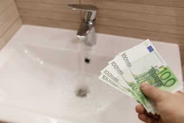 Euro bills in male hands. Euro cash background.