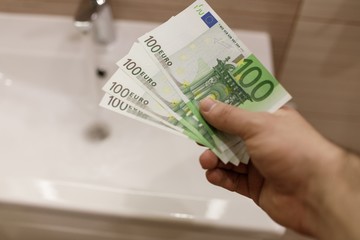 Euro bills in male hands. Euro cash background.