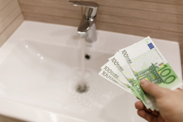 Euro bills in male hands. Euro cash background.