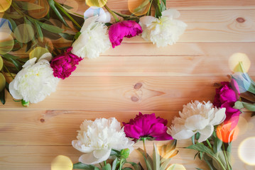 Red and white peony flowers on wooden background with copy space for greeting message.