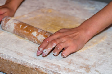 Hands working with dough preparation recipe bread. Female hands making dough for pizza. Woman's hands roll the dough