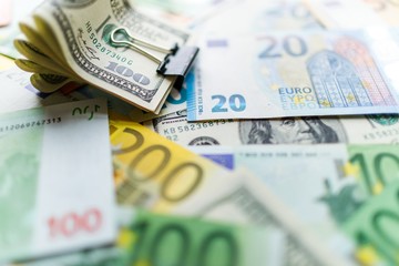 Background with american dollar and euro bills.