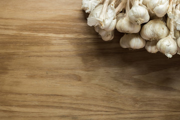 Garlic cloves on wooden vintage background.