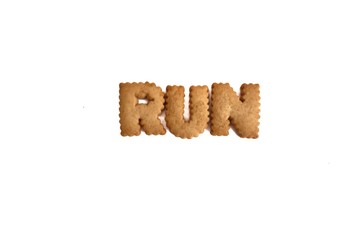 A biscuit alphabet of the word RUN on white isolated background 
