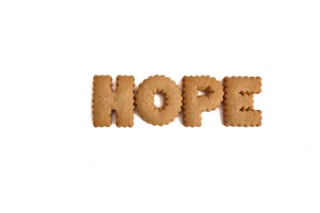 Crispy biscuit alphabets with the word  of Hope on white isolated background 