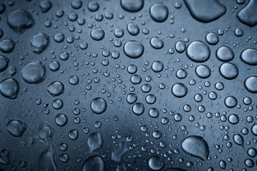 Water drops on metal surface. Macro with shallow depth of field.