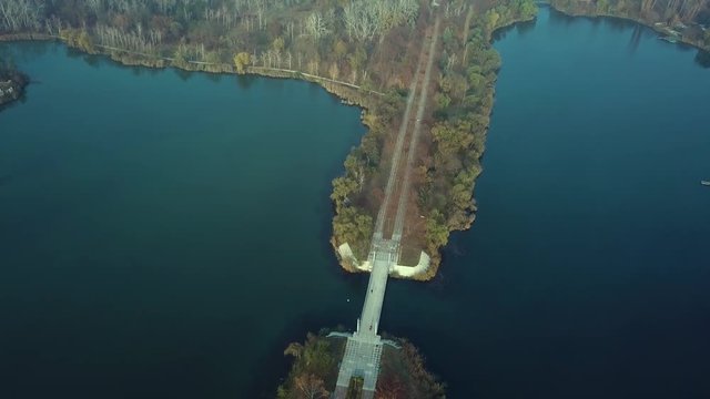 Aerial footage over Echo Park Lake, Kishinev, Moldova republic of. View of lake and smille bridge.