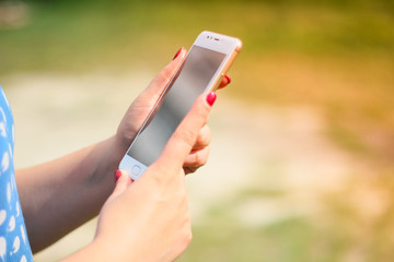 Woman with mobile phone, outdoors