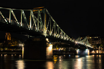 Fototapeta na wymiar Illuminated bridge in Frankfurt am Main on the night. Germany