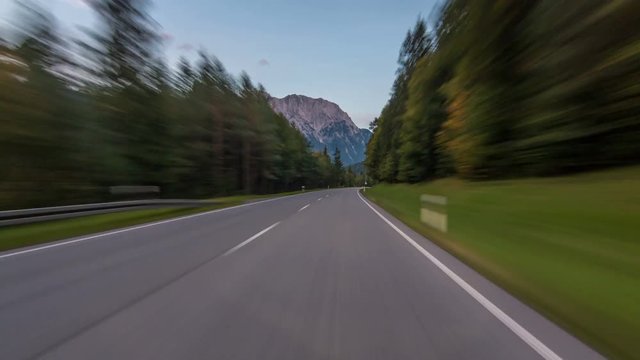 Asphalt road in Austria, Alps in a beautiful autumn day timelapse hyperlapse drivelapse
