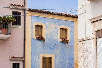 Travel to Italy -  historical street of Acitrezza, Catania, Sicily, facade of ancient buildings.
