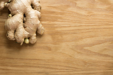 Ginger root sliced on wooden background 