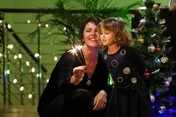 Mom and daughter play with bright stars