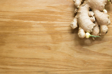 Ginger root sliced on wooden background 