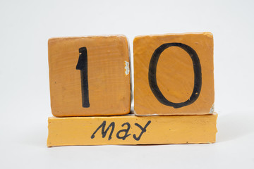 may 10th. Day 10 of month, handmade wood calendar isolated on white background. Spring month, day of the year concept
