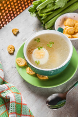 Chicken broth with sliced egg and crackers