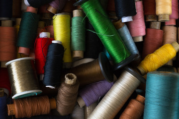 Top view on many old colorful sewing threads