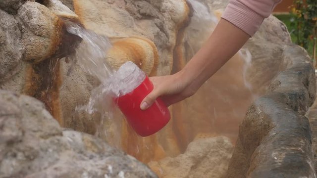 Natural mineral hot spring flows out in a fountain for drink