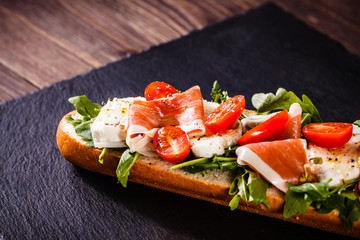 Long sandwich on black stone plate