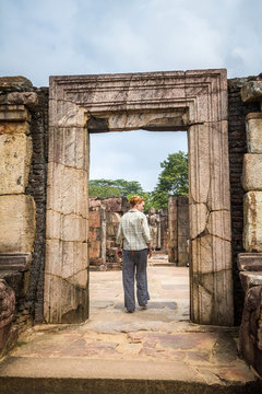 Girl walking through the temple. Sri Lanka, Polonnaruwa, Royal Palace of King Parakramabahu