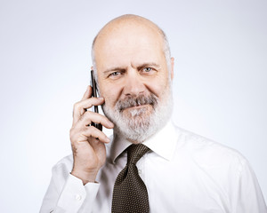 Happy mature man calling with his phone