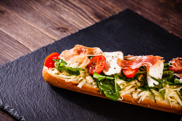 Long sandwich on black stone plate