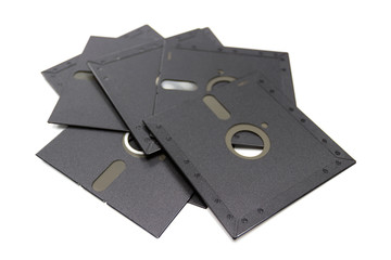 A floppy disk, also called a diskette or just disk, is a type of disk storage composed of a disk of thin and flexible magnetic storage medium, sealed in a rectangular - isolated - white background 