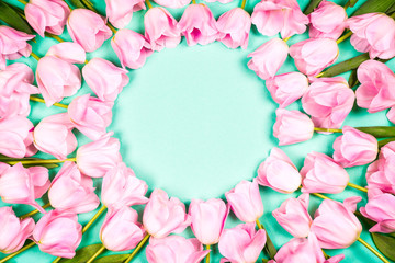 spring flowers banner - bunch of pink tulip flowers on blue sky background.