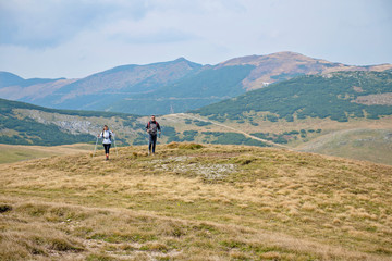 Fototapeta na wymiar Sporty hikers on path with trekking poles