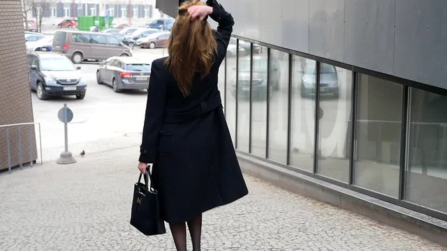 Young woman walking down the street.
