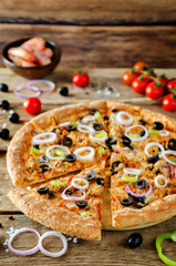 Pizza with tuna, olives, green pepper and red onion