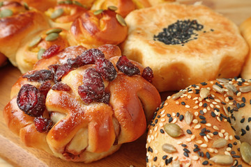 Closed Up Bread with Dried Fruits and Another Various Types of Fresh Made Breads Served on Wooden Tray 
