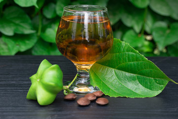 Sacha Inchi, fresh capsule seeds fruit of sacha-Inchi peanut with  tea on green leaf background
