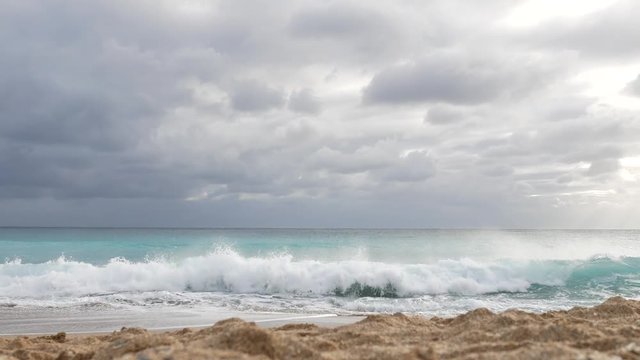 Waves on beach on cludy day