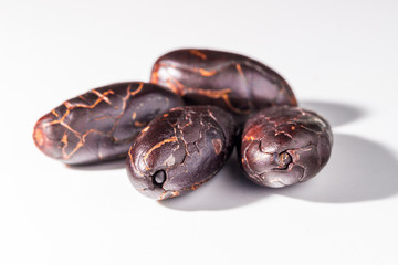 peeled cocoa beans on white background