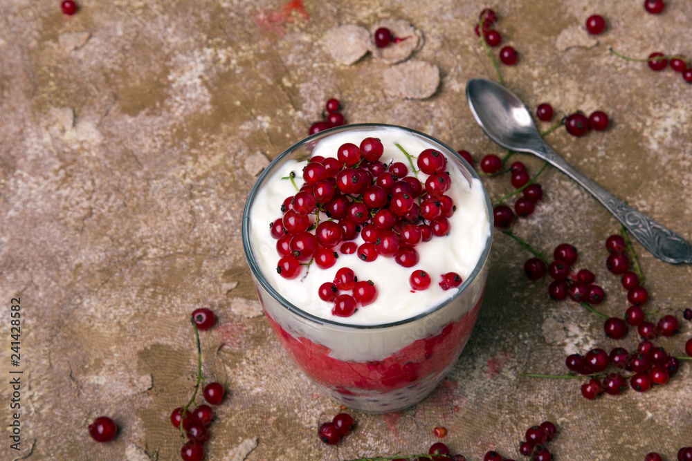 Canvas Prints Healthy dessert with organic red currants, fresh yogurt and corn flakes. Dietary breakfast on a brown background