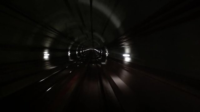 Fast underground train riding in a tunnel of the modern city