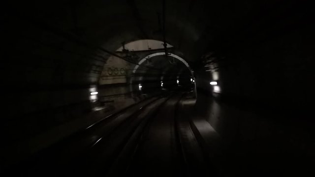 Fast underground train riding in a tunnel of the modern city