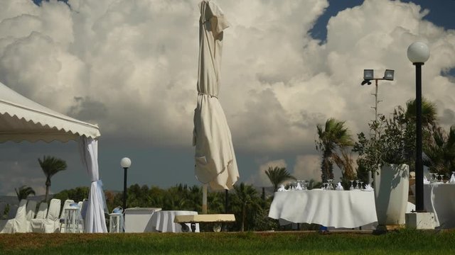 Cloudy windy landscape view with open-air preparing buffet in white colours on peaceful innocent nature