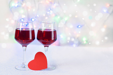 Two glasses of wine and a Valentine on a white background, greeting card