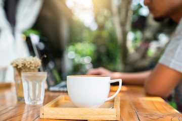 Morning cofee cup with blur man working