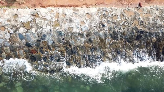 4k Footage of wave splash on the coast built from random texture rocks