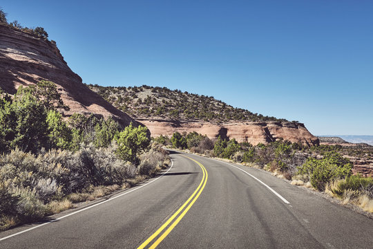 Mountain road in Colorado, retro color toned picture, USA.